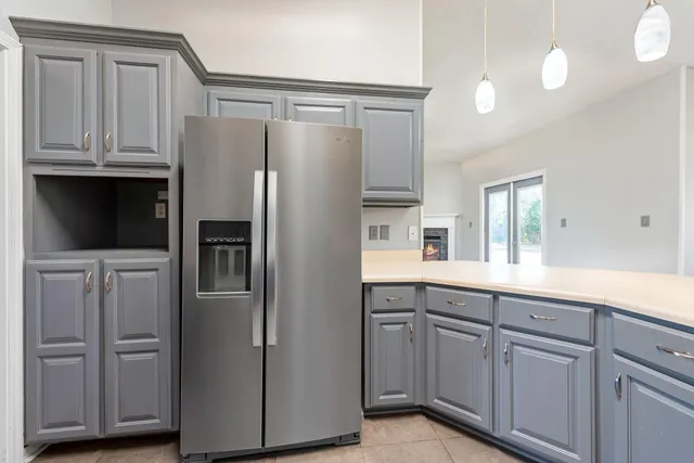 a kitchen with white cabinets and stainless steel appliances