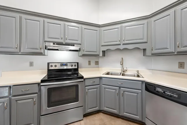 a kitchen with cabinets appliances and a sink