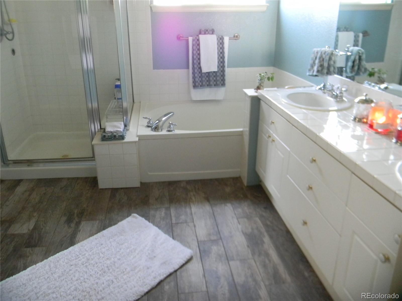 4092 Starflower Road Castle Rock, CO 80109 - Photo 14 of 28 a bathroom with a tub sink and mirror