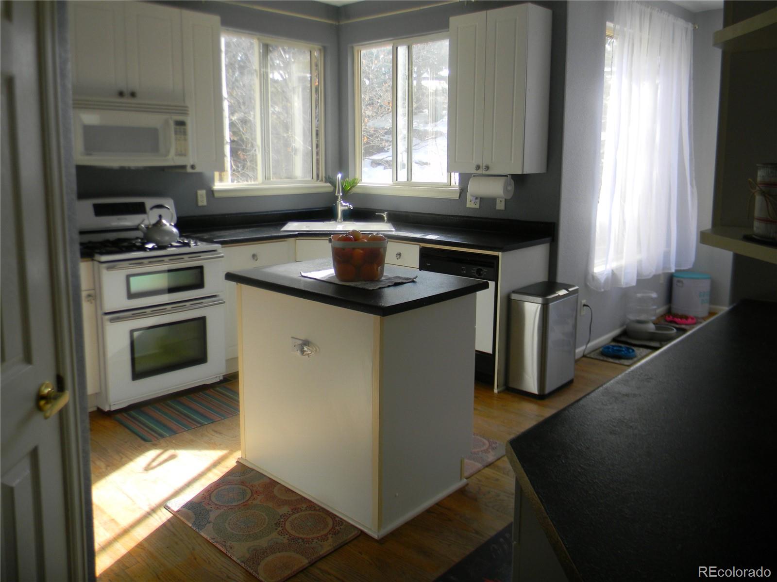 4092 Starflower Road Castle Rock, CO 80109 - Photo 5 of 28 a kitchen that has a sink and a stove