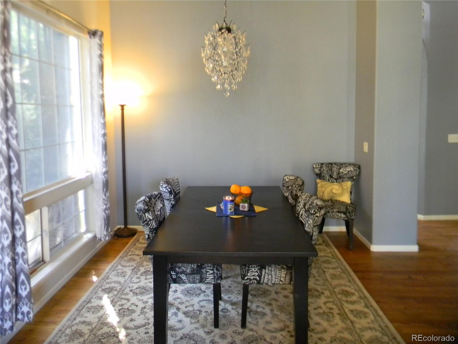 4092 Starflower Road Castle Rock, CO 80109 - Photo 8 of 28 a view of a dining room with furniture and a window