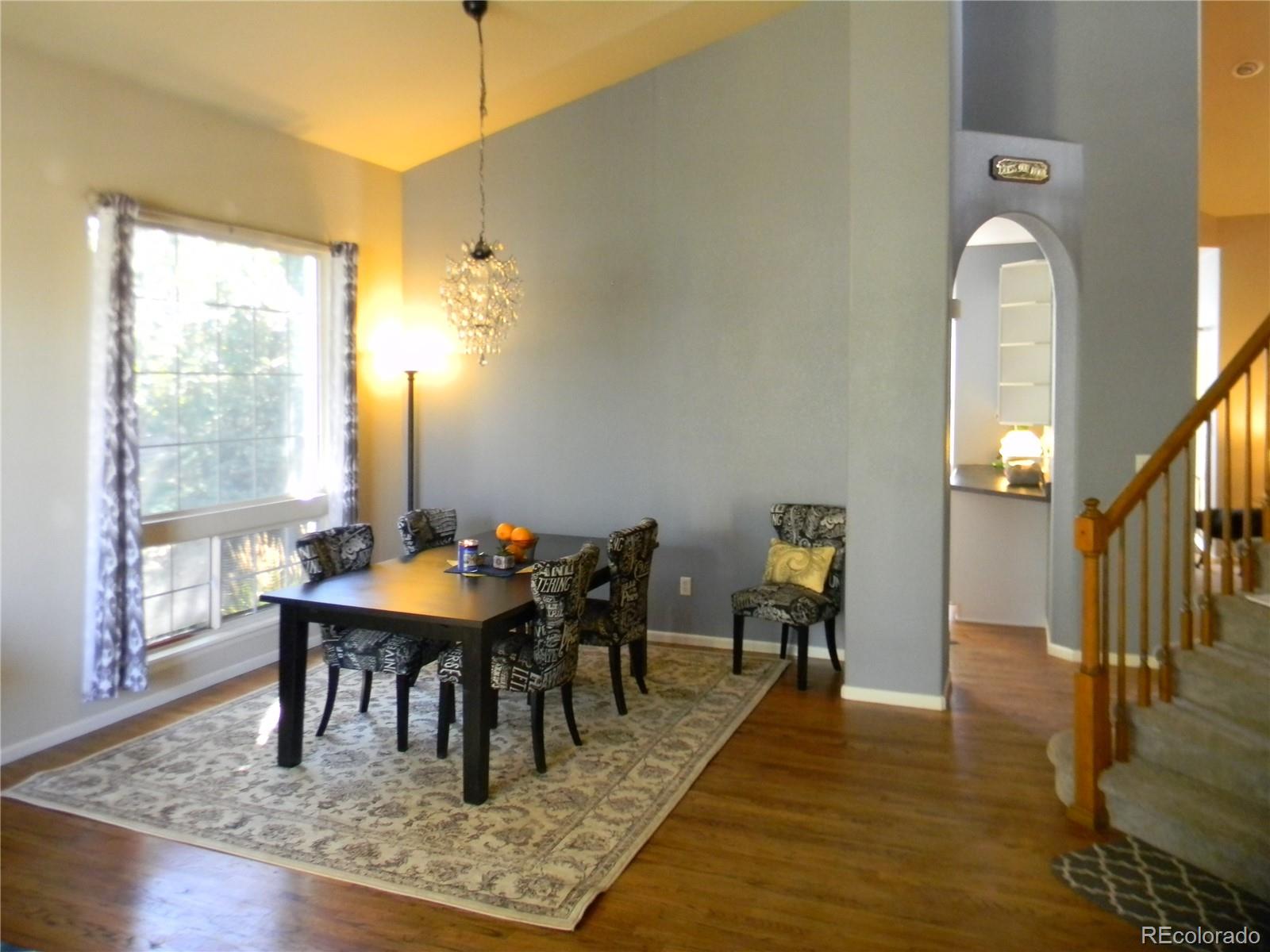 4092 Starflower Road Castle Rock, CO 80109 - Photo 9 of 28 a view of a dining room with furniture and wooden floor