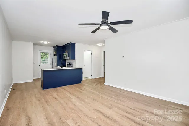 a kitchen with stainless steel appliances kitchen island granite countertop a refrigerator and a sink