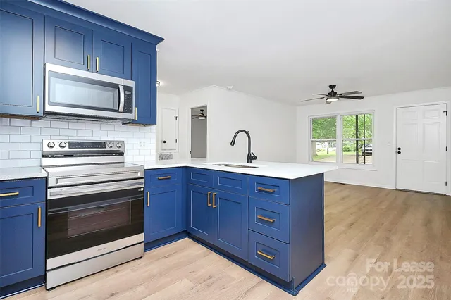 a kitchen with wooden cabinets and stainless steel appliances