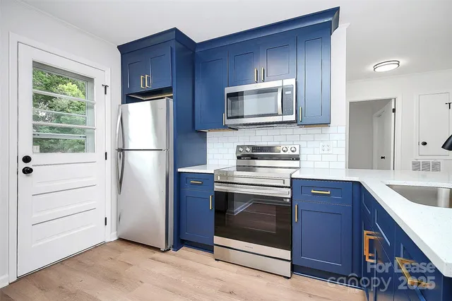 a kitchen with a refrigerator stove and microwave