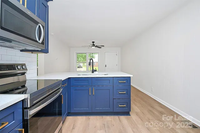 a kitchen with wooden cabinets and a stove top oven