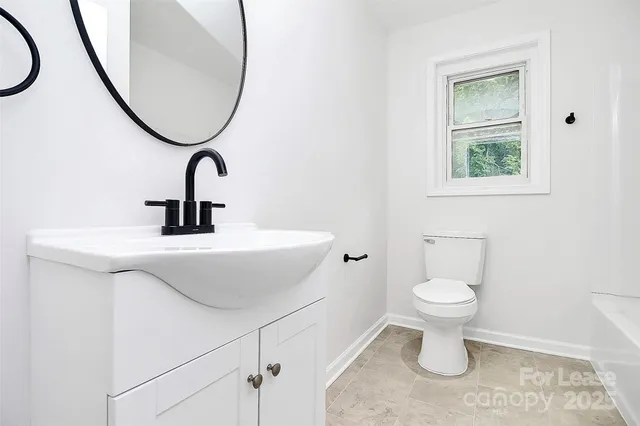 a bathroom with a sink toilet and a mirror