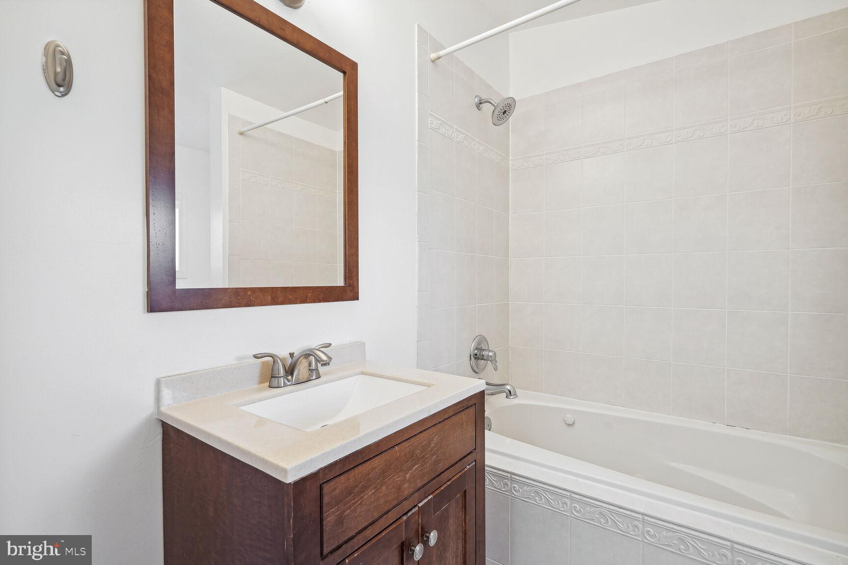 4528 4th Street Northwest Washington, DC 20011 - Photo 16 of 28 a bathroom with a sink vanity toilet and shower