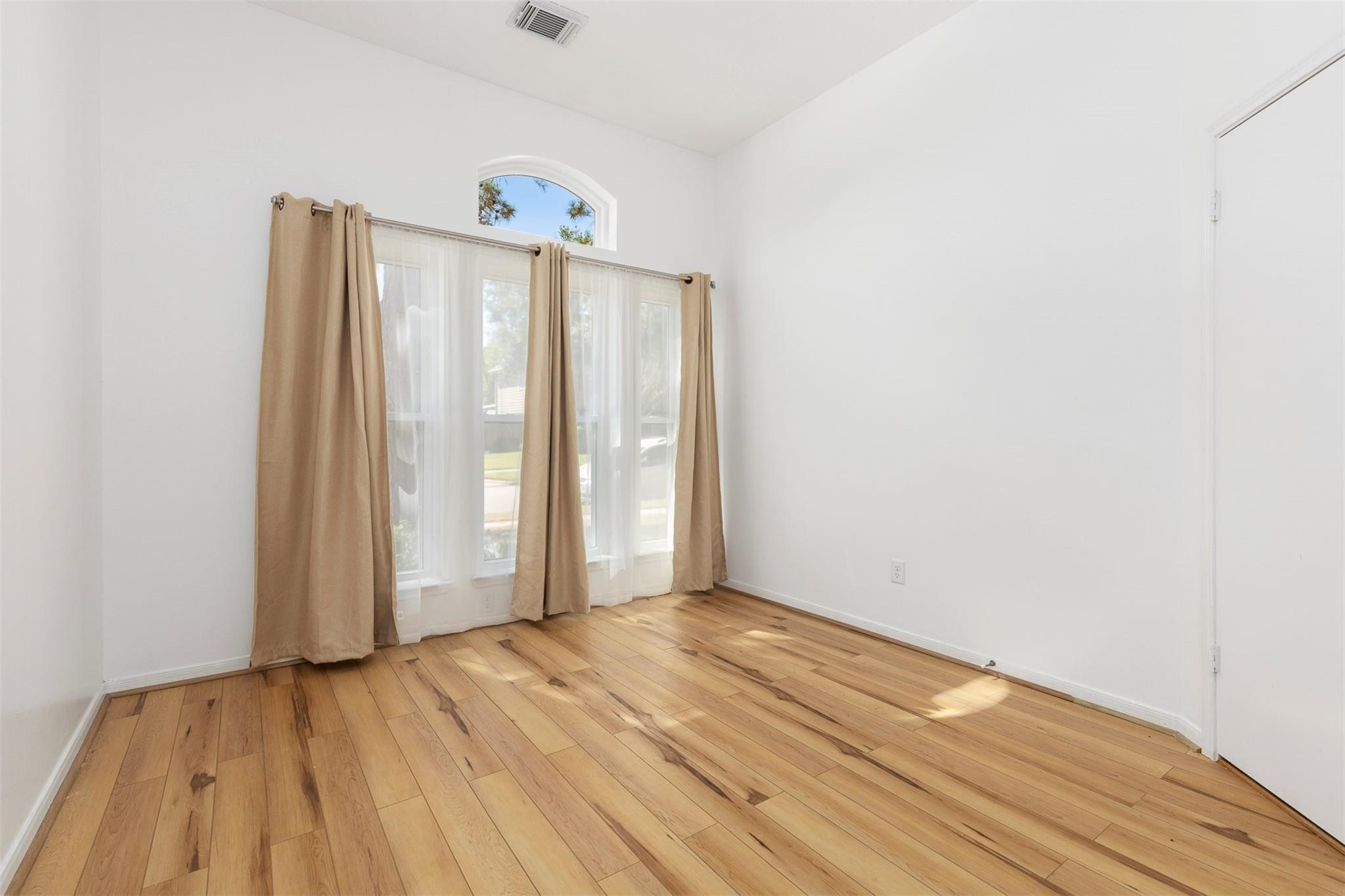 3406 Meadowlark Lane Spring, TX 77388 - Photo 13 of 19 an empty room with wooden floor and a window