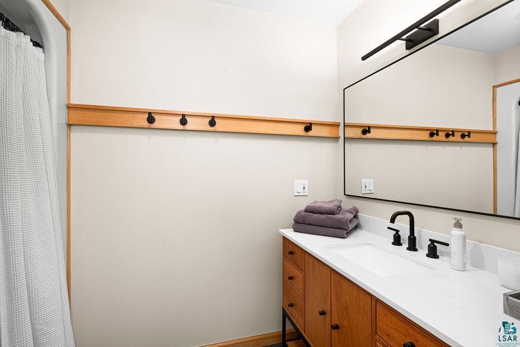4856 Kingston Street Duluth, MN 55804 - Photo 38 of 88 Modern bathroom vanity featuring a rectangular undermount sink, white countertop, and matte black faucet