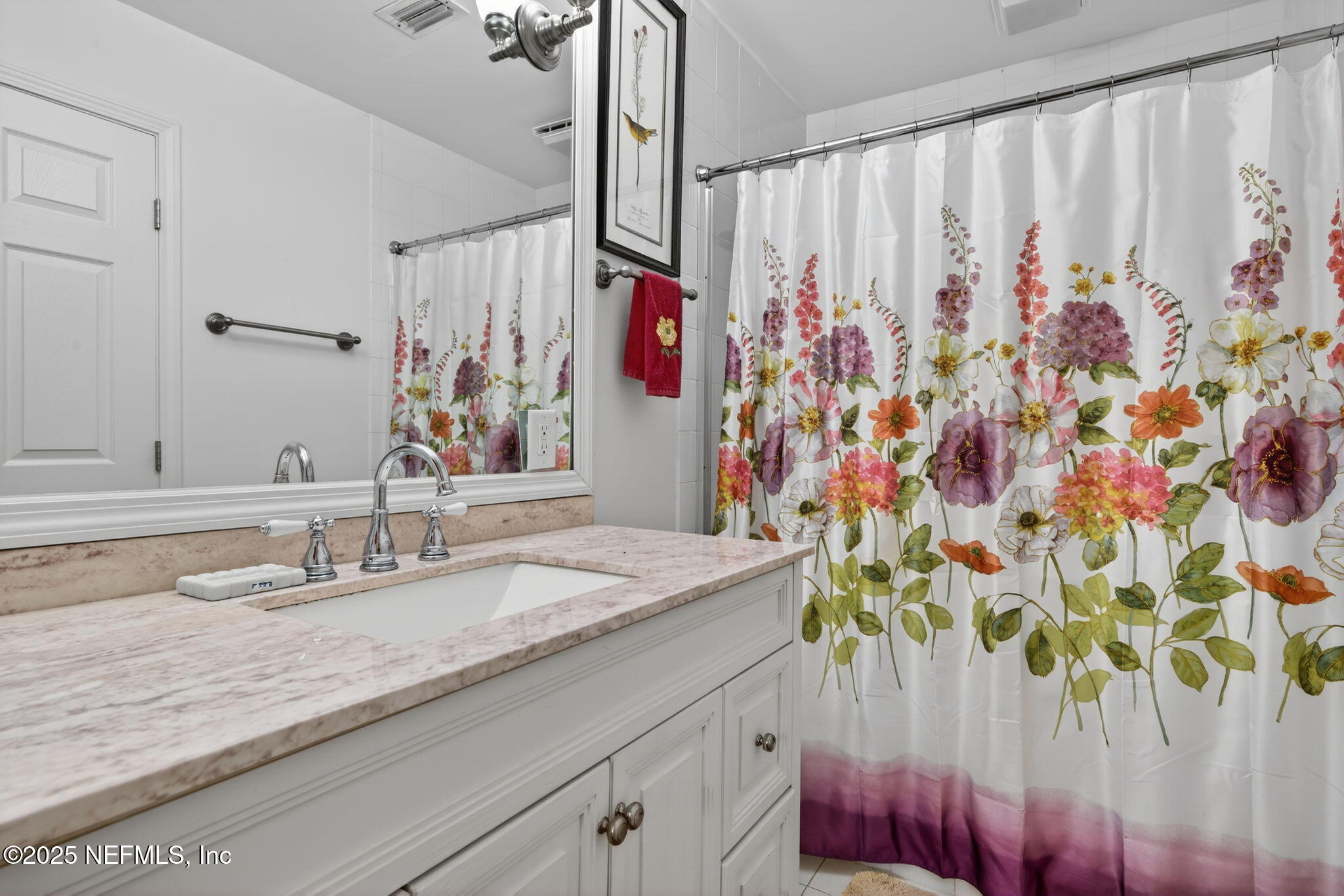 4980 Morven Road Jacksonville, FL 32210 - Photo 21 of 35 a bathroom with a granite countertop sink a mirror and shower curtain