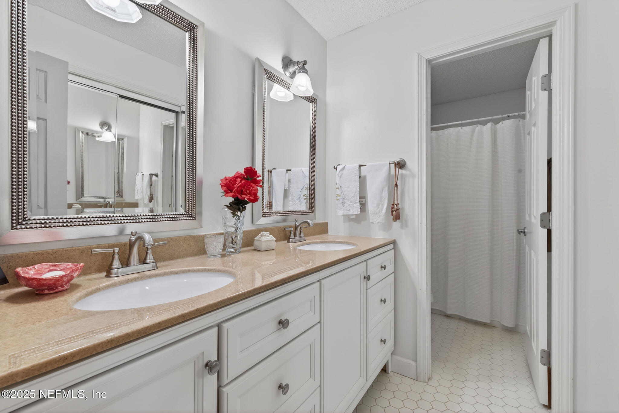 4980 Morven Road Jacksonville, FL 32210 - Photo 26 of 35 a bathroom with double sink and a mirror