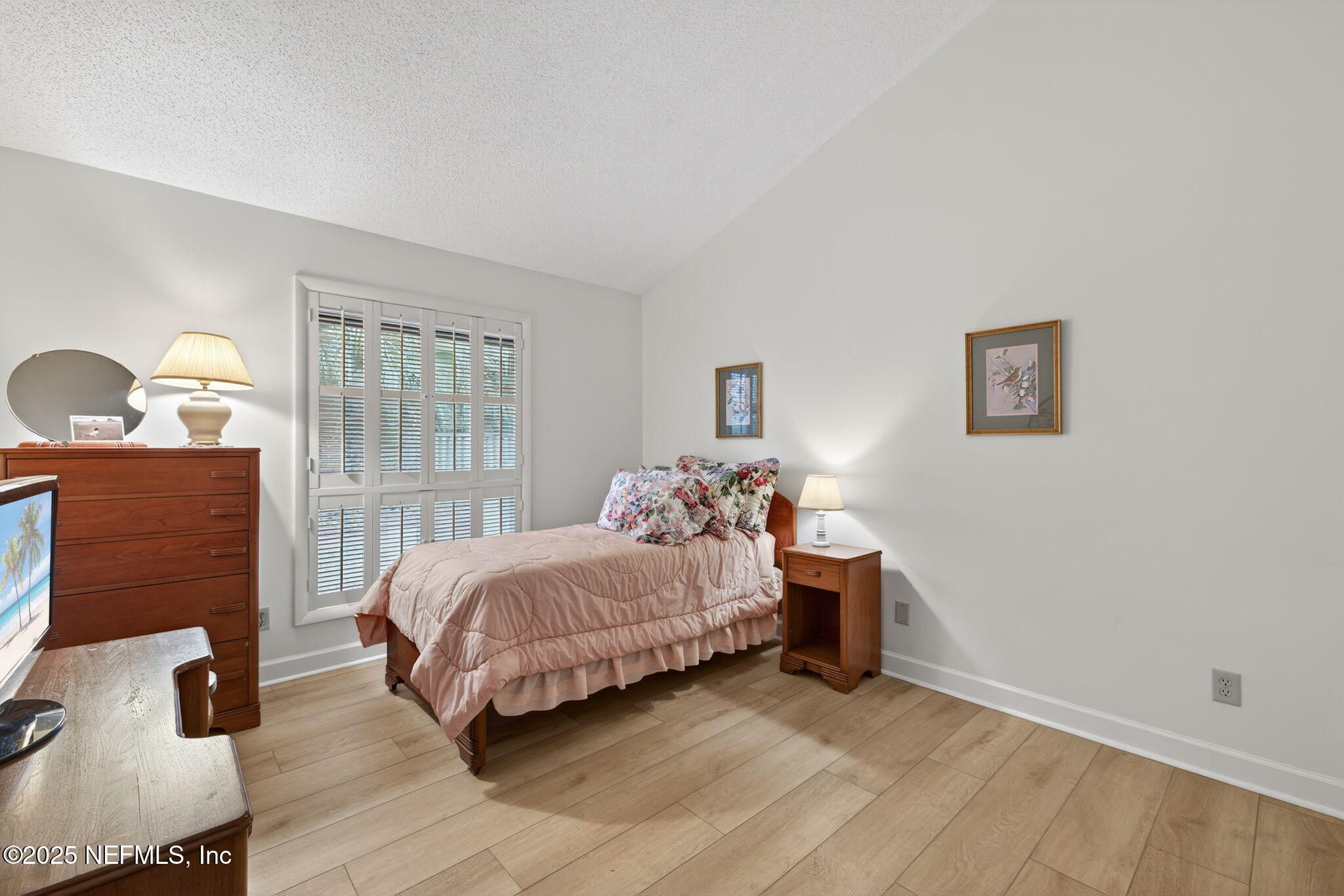 4980 Morven Road Jacksonville, FL 32210 - Photo 27 of 35 a bedroom with a bed and wooden floor
