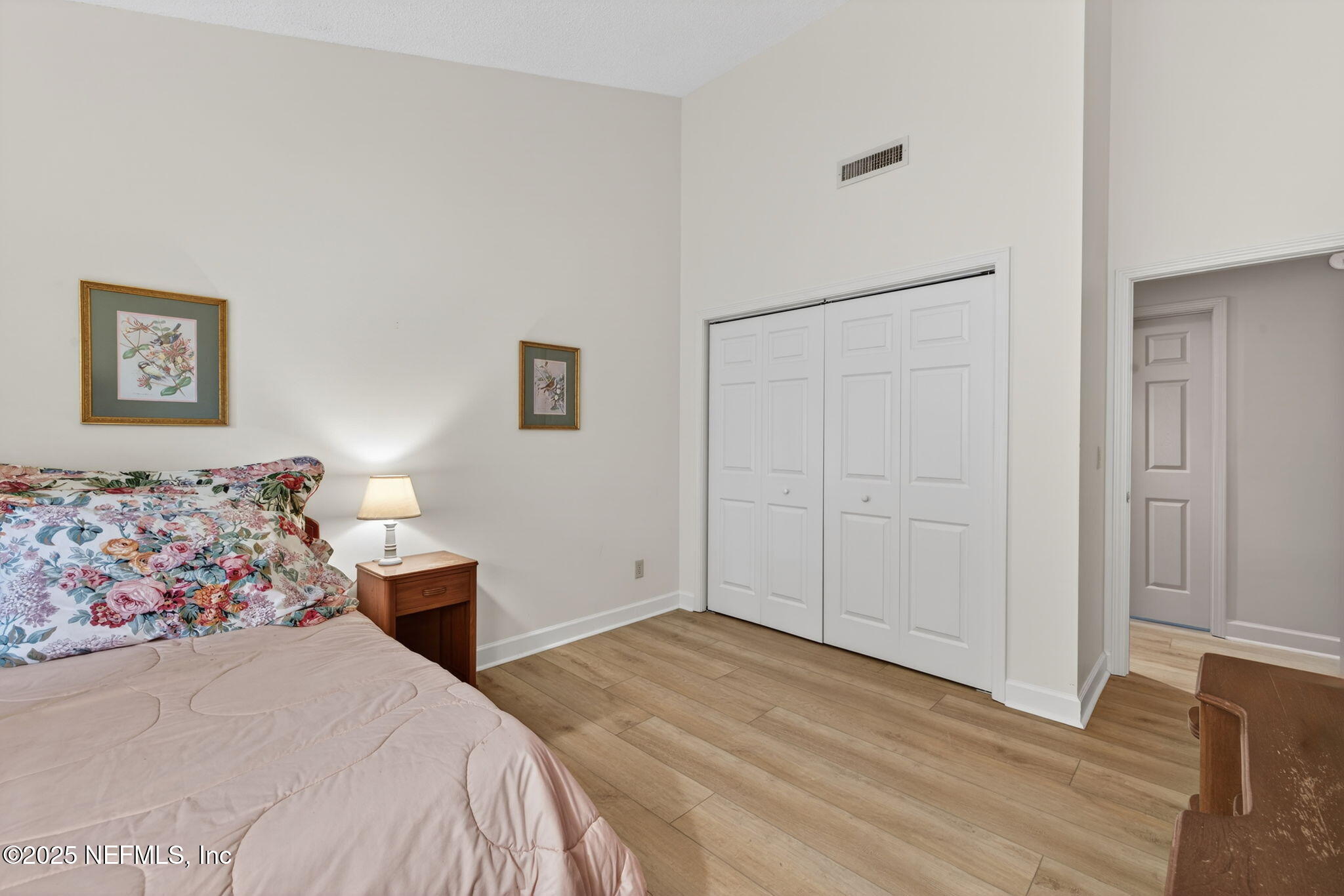 4980 Morven Road Jacksonville, FL 32210 - Photo 28 of 35 a bedroom with a bed and a painting on the wall