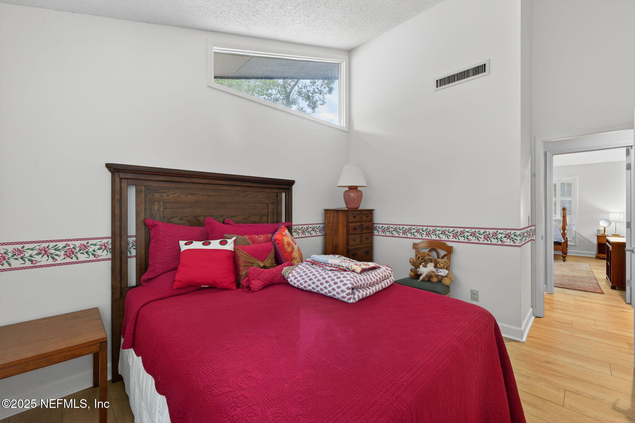 4980 Morven Road Jacksonville, FL 32210 - Photo 30 of 35 a bedroom with a bed and wooden floor