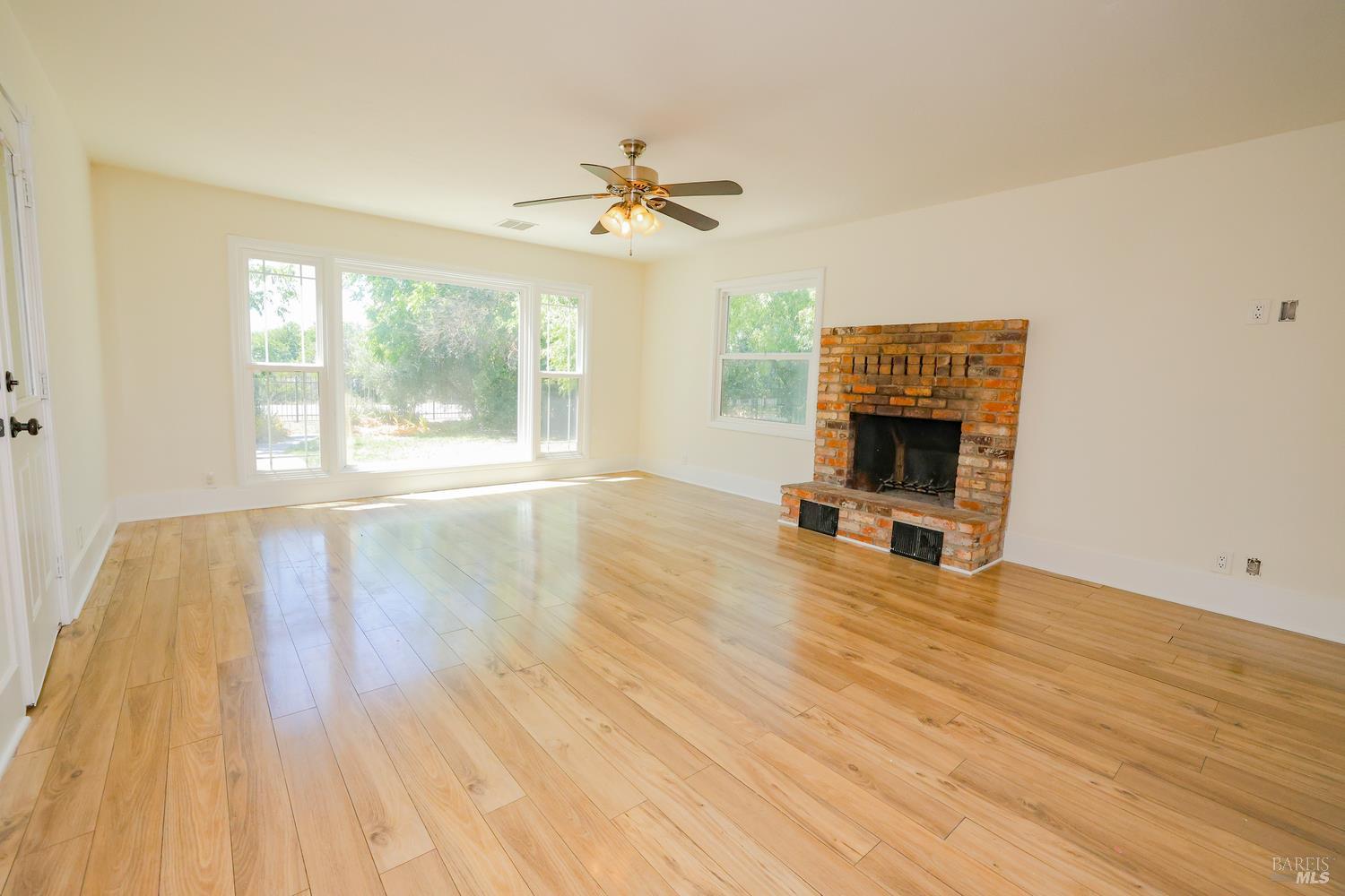 7948 North Meridian Road Dixon, CA 95620 - Photo 19 of 59 a view of empty room with wooden floor and fan