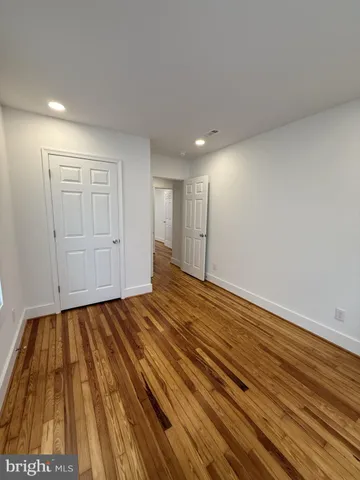 a view of an empty room and wooden floor