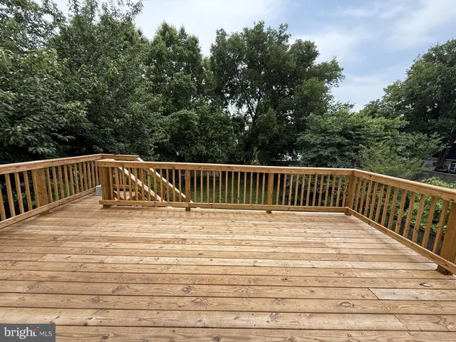 a view of wooden deck and a yard