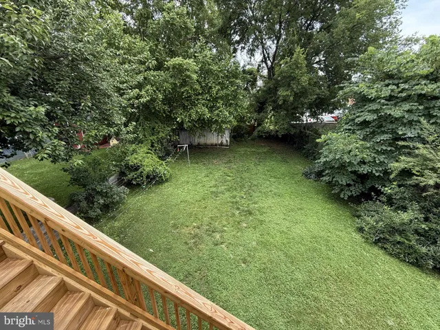 a view of balcony with wooden floor and fence