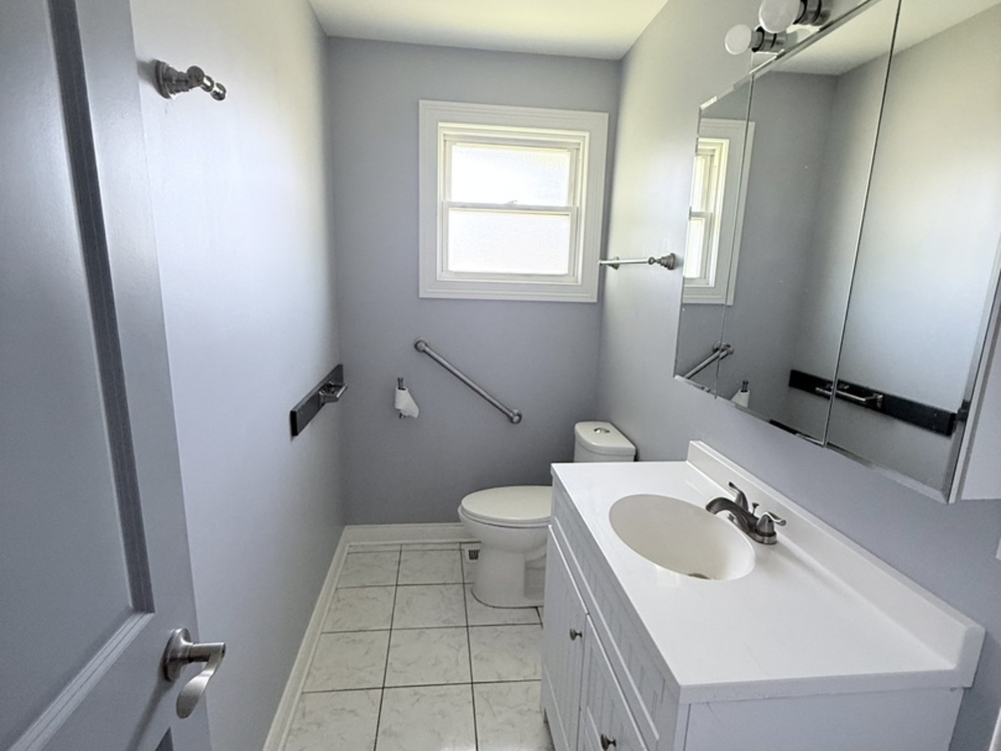 8356 South 78th Avenue Bridgeview, IL 60455 - Photo 12 of 39 a bathroom with a sink a toilet and a mirror