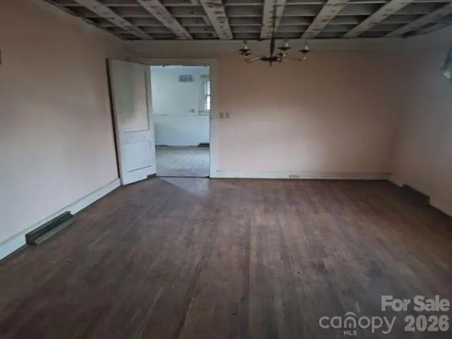 a view of a room with wooden floor