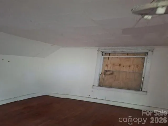 an empty room with wooden floor and closet