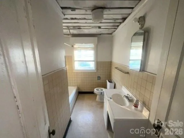 a bathroom with a sink a window and a shower