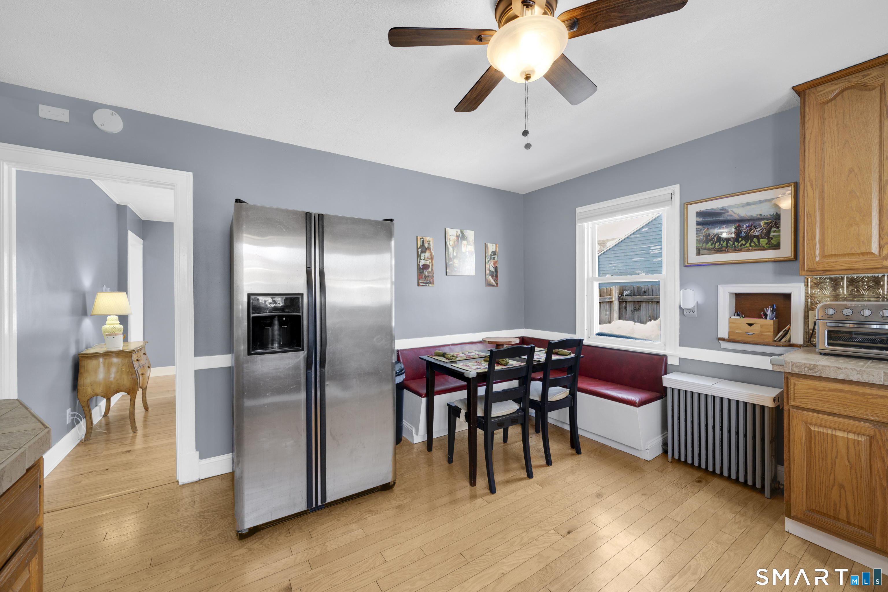 80 Cowles Street Hartford, CT 06114 - Photo 12 of 30 a dining room with furniture a flat screen tv and kitchen view