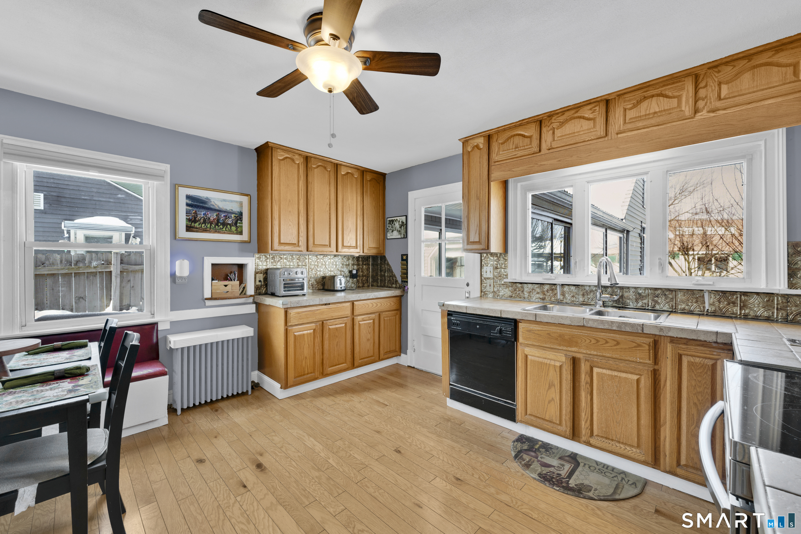 80 Cowles Street Hartford, CT 06114 - Photo 13 of 30 a kitchen with a refrigerator cabinets and wooden floor