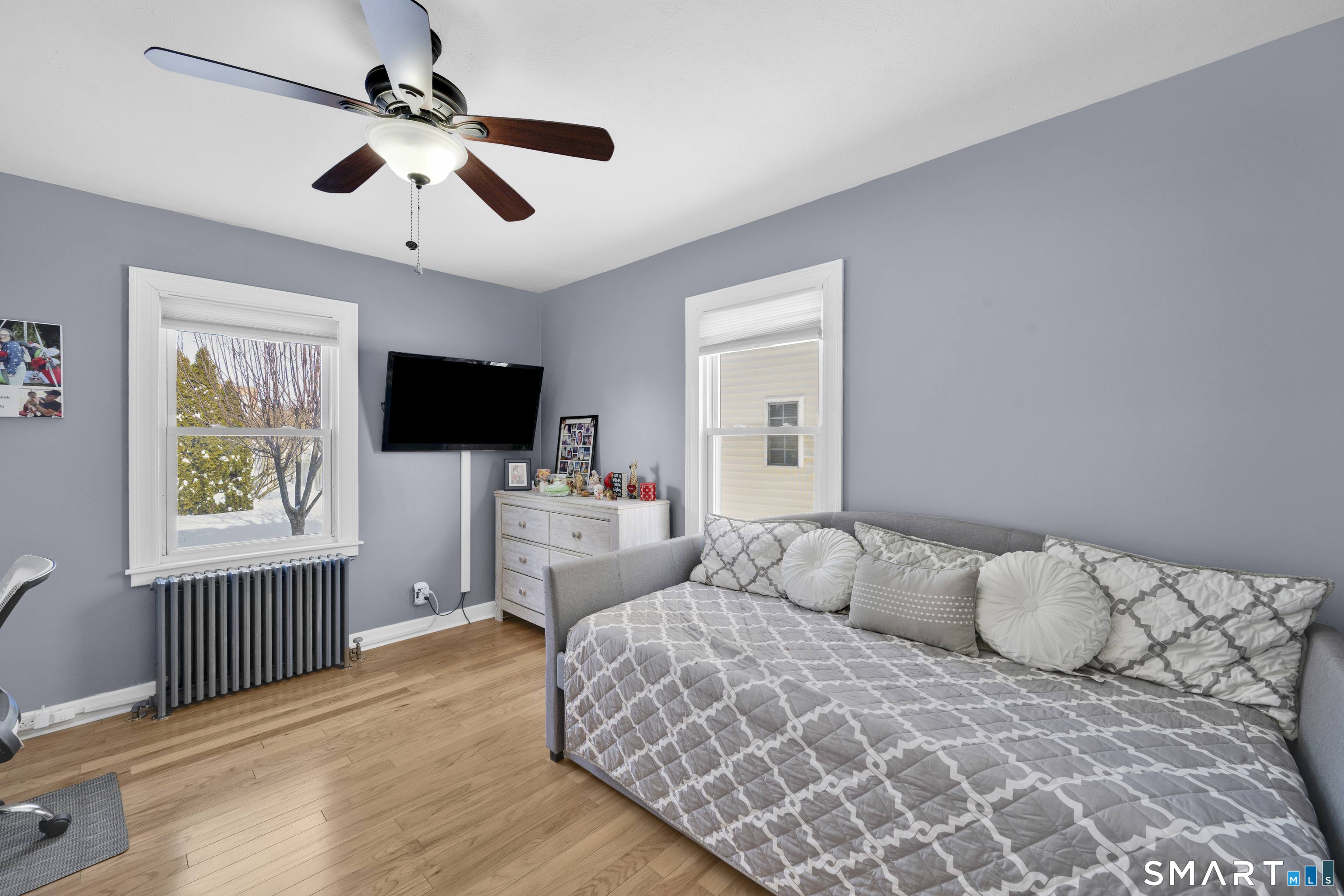 80 Cowles Street Hartford, CT 06114 - Photo 15 of 30 a bedroom with a bed window and a flat screen tv