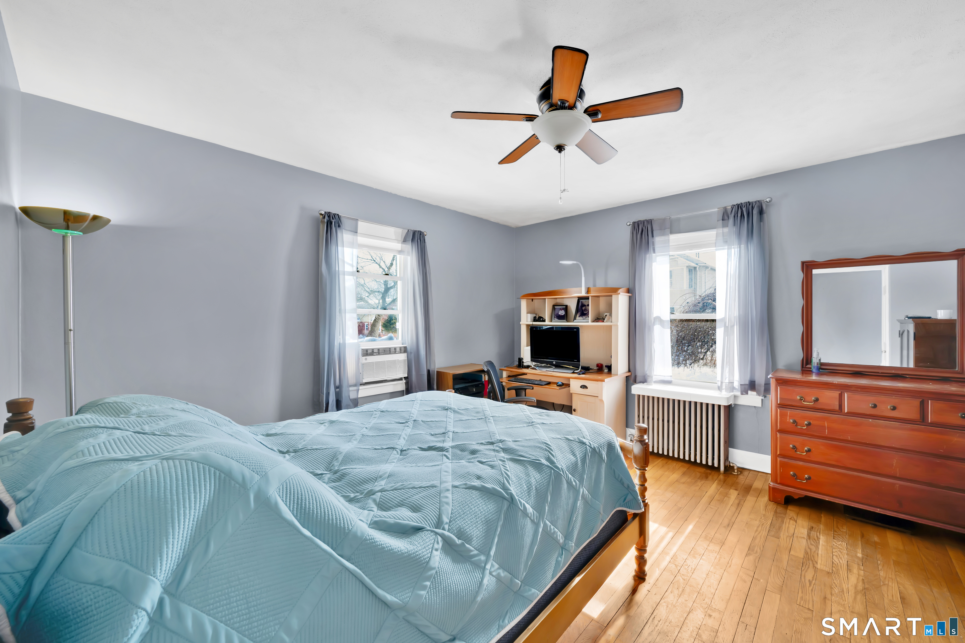 80 Cowles Street Hartford, CT 06114 - Photo 17 of 30 a bedroom with a bed a dresser and a flat screen tv
