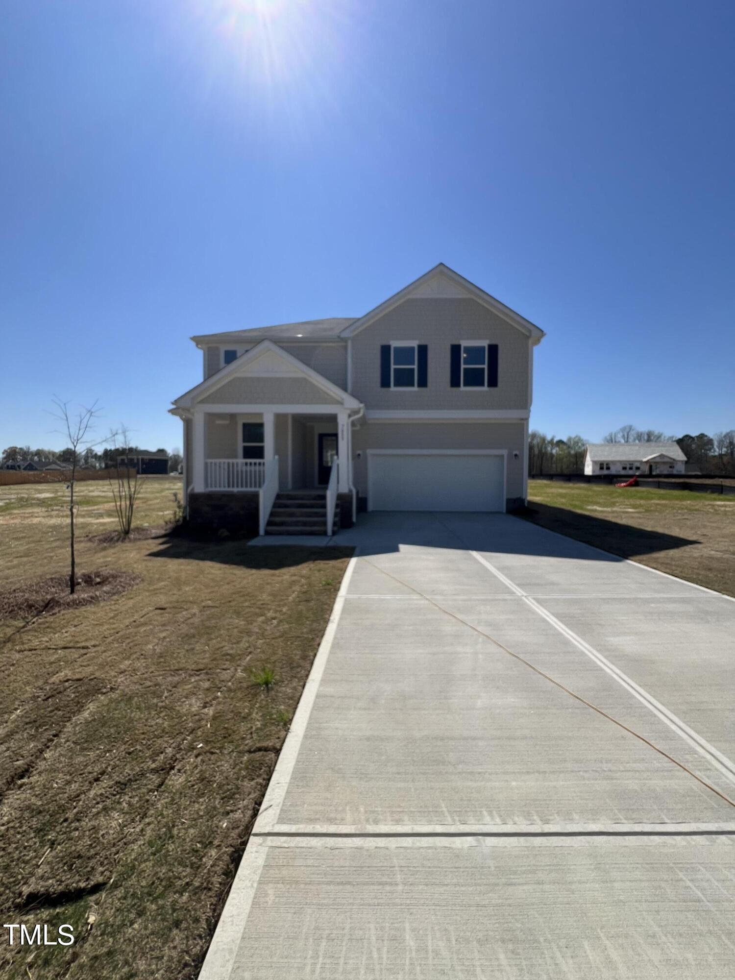 7633 Redwood Rdg Way Willow Spring, NC 27592 - Photo 2 of 10 a front view of a house with a yard and ocean view