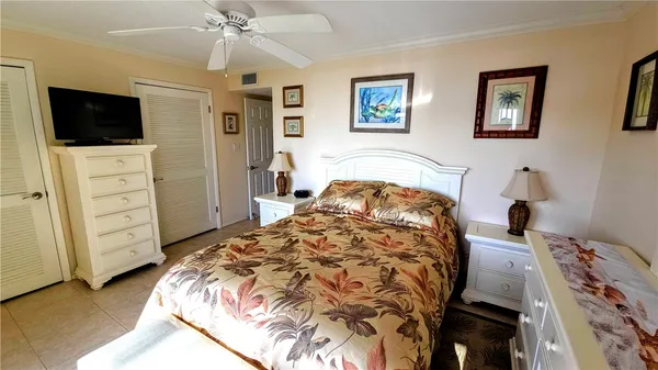 a bed sitting in a bedroom and tv