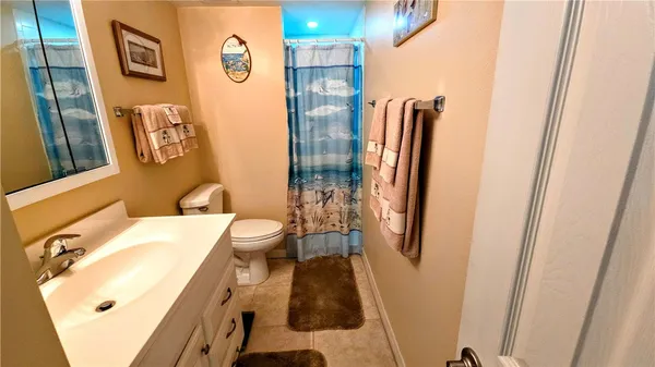 a bathroom with a sink and mirror with toilet