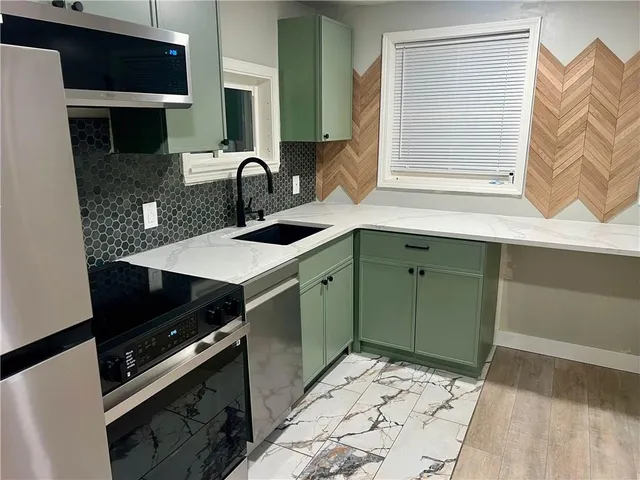 a kitchen with a sink stove and cabinets