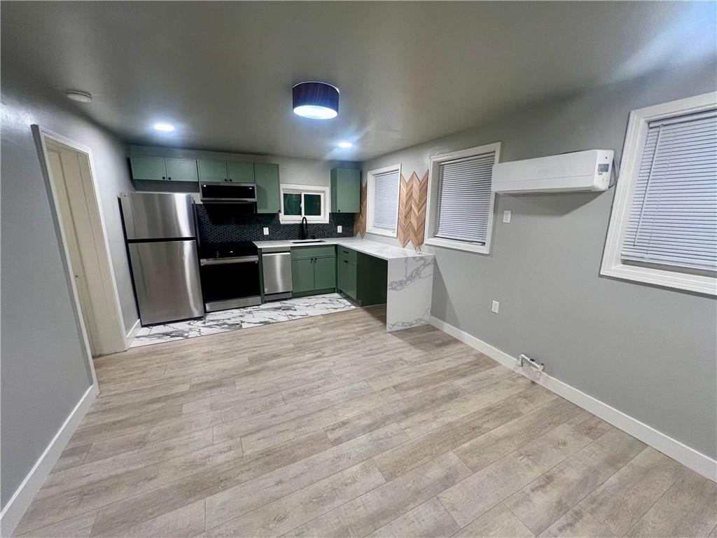 926 Moreland Avenue Southeast, Unit B Atlanta, GA 30316 - Photo 4 of 12 a kitchen with stainless steel appliances kitchen island granite countertop a refrigerator and a sink