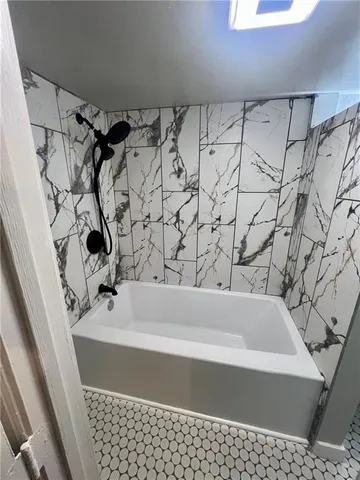 a bathroom with a bathtub and shower