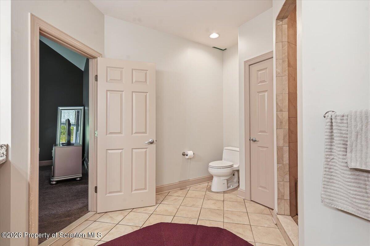 99 Hilltop Road Waverly, PA 18471 - Photo 31 of 41 a bathroom with a toilet a sink and mirror