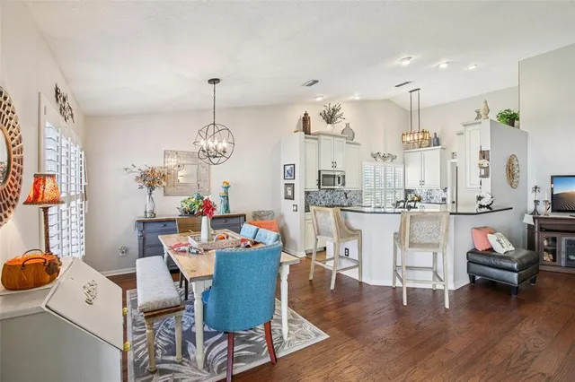 a view of a dining room with furniture wooden floor and a chandelier