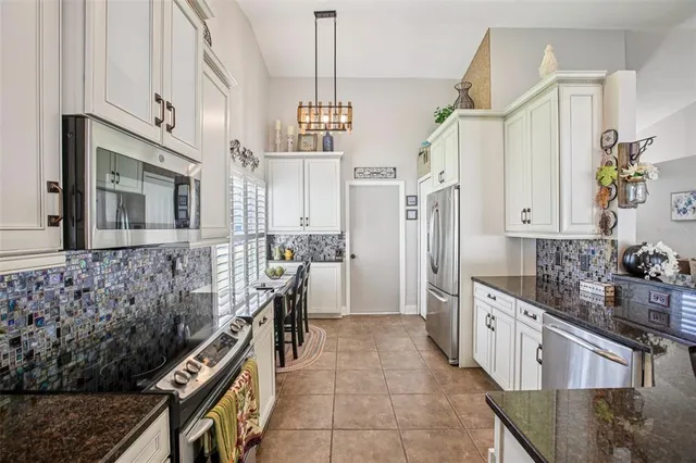 a kitchen with cabinets and window