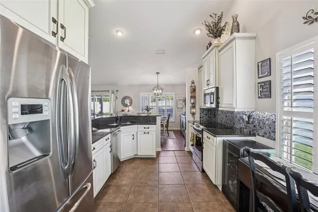 a kitchen with stainless steel appliances a sink stove and refrigerator