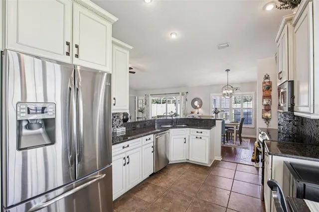 a kitchen with appliances a sink and cabinets