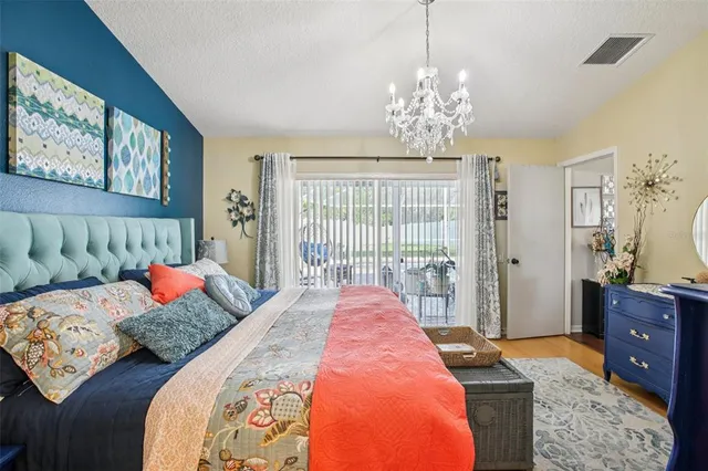 a bed sitting in a bedroom next to a window