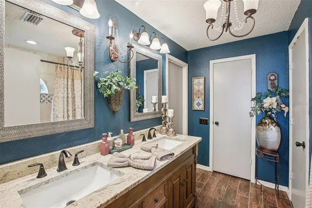 a spacious bathroom with a granite countertop sink a large mirror and a shower