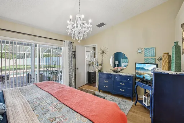 a bedroom with a bed and a chandelier