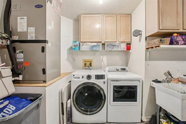 a utility room with closet dryer and washer
