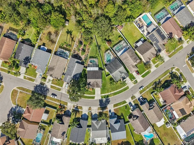 an aerial view of residential houses with outdoor space