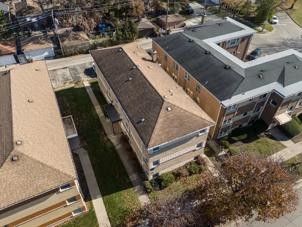 an aerial view of a residential apartment building with a yard