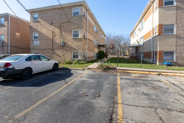 a view of a cars park in front of a building
