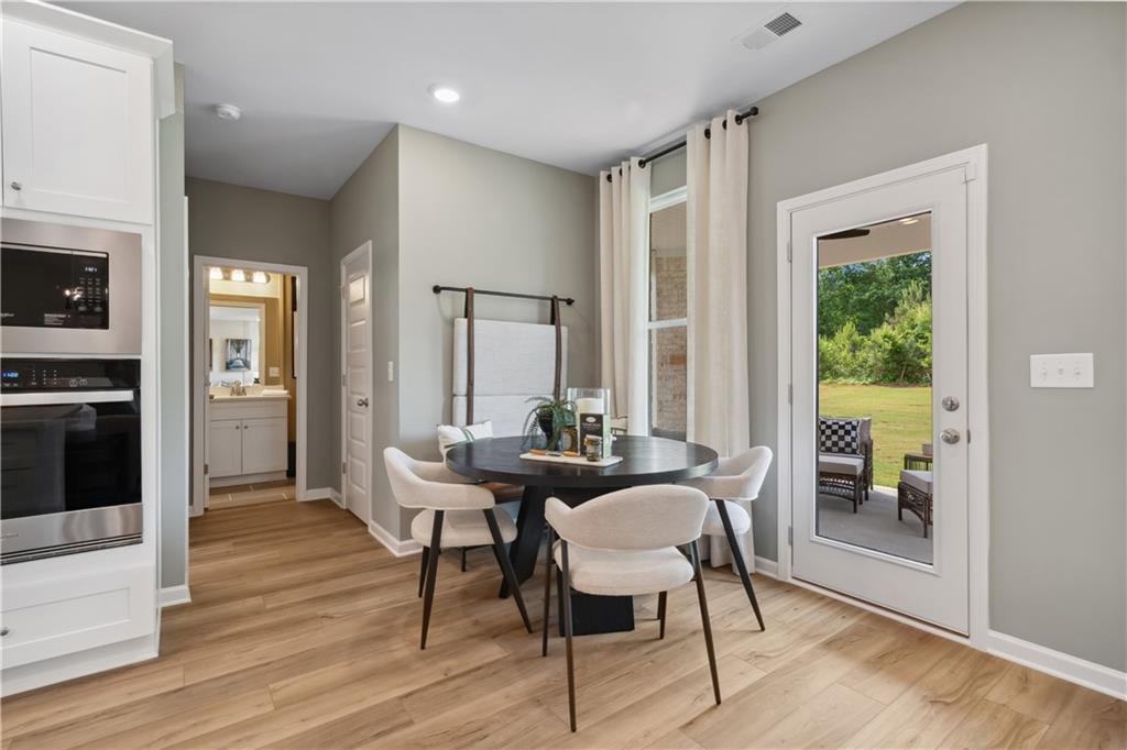 412 Hartsfield Road McDonough, GA 30252 - Photo 19 of 43 a dining room with furniture and wooden floor